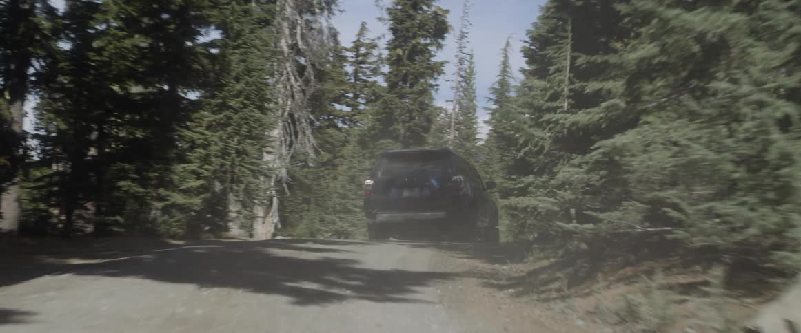 A truck drives up a mountain road