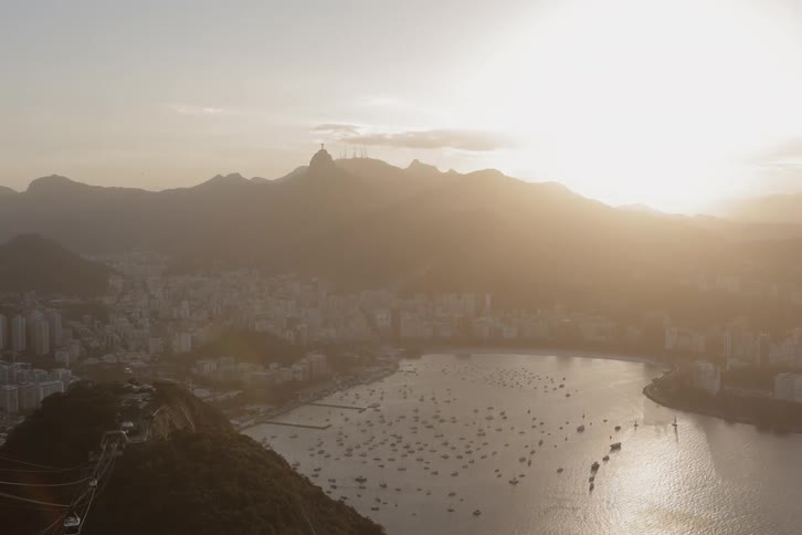 The sun sets over a city and lake