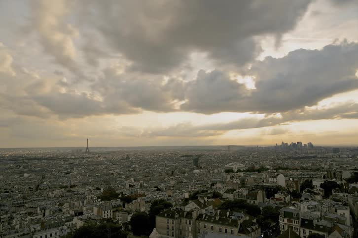 Clouds pass over a tower and a city