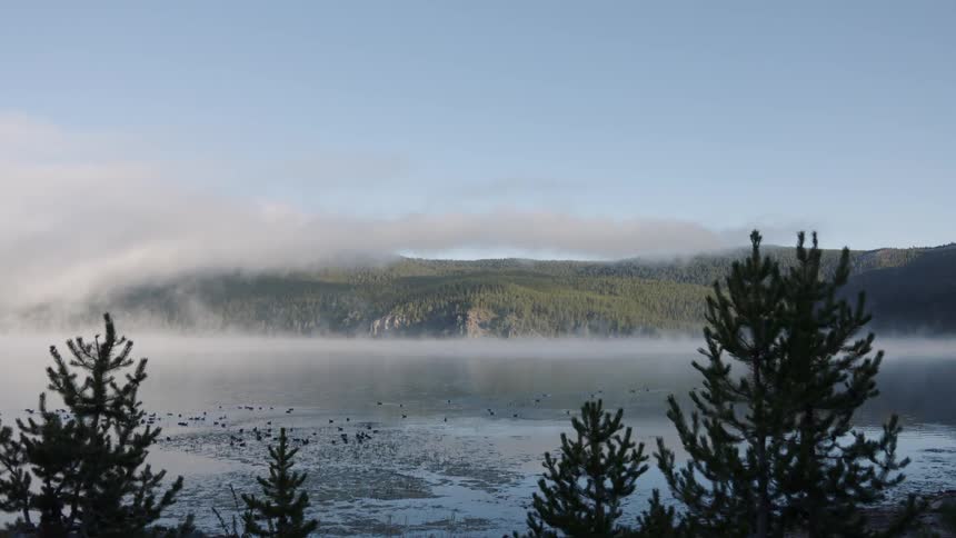 Mist floats above a mountain lake