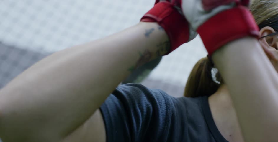 A woman softball player prepares to hit the ball