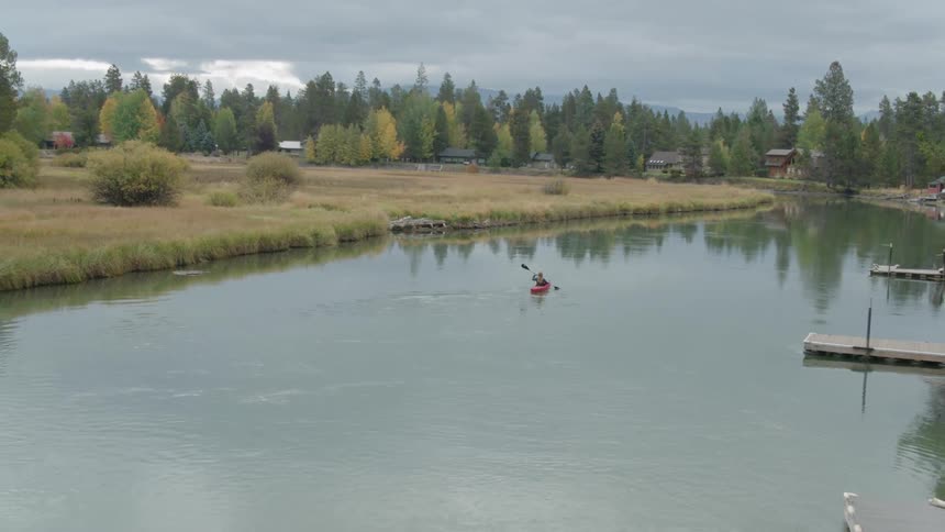 A woman kayaks on the water