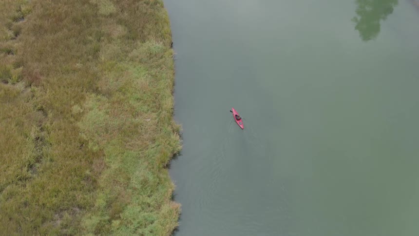 A woman kayaks on the water