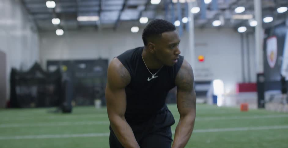 An athlete warms up on an indoor field