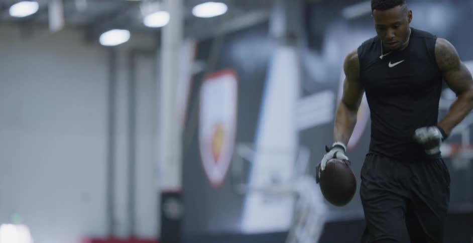 A football player trains indoors