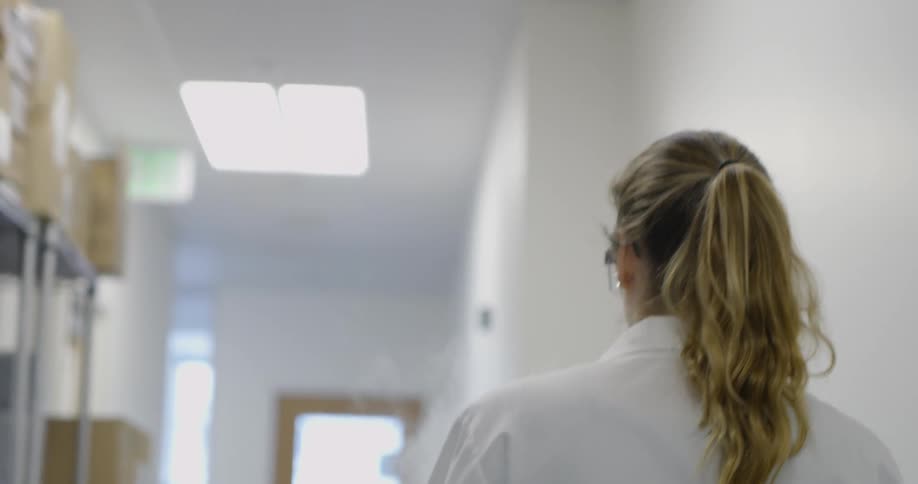 A scientist walks in a laboratory