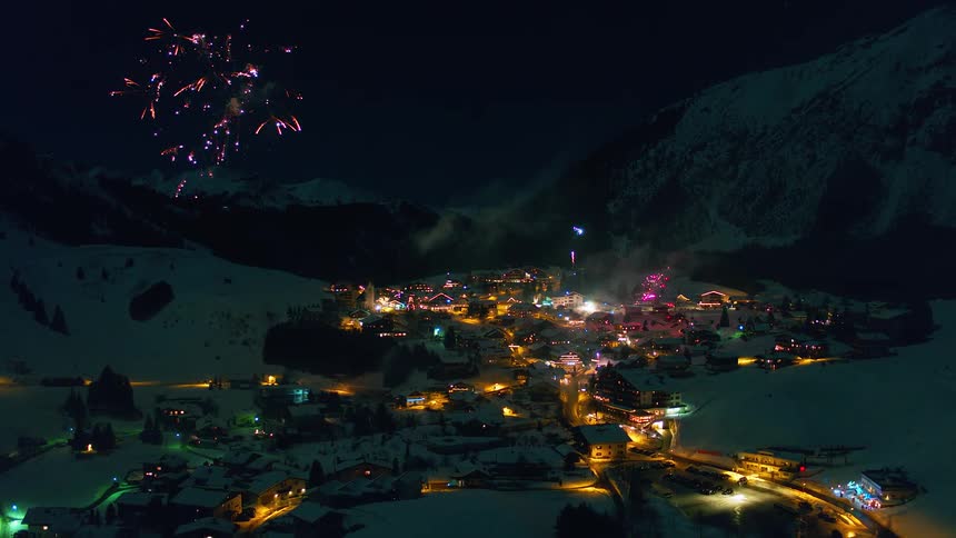 Fireworks explode above a snowy village
