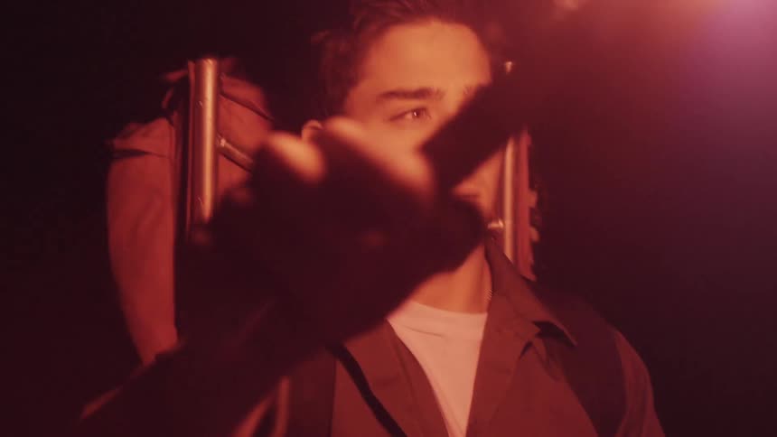 Man waves a flare in front of him to light up the area