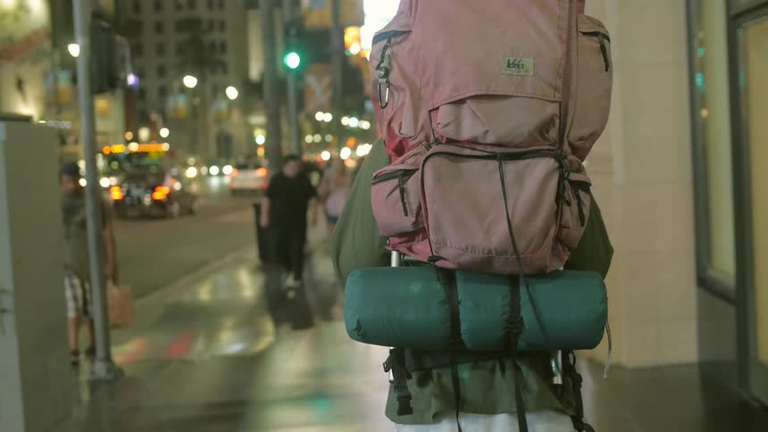 People walking up and down a city street at night