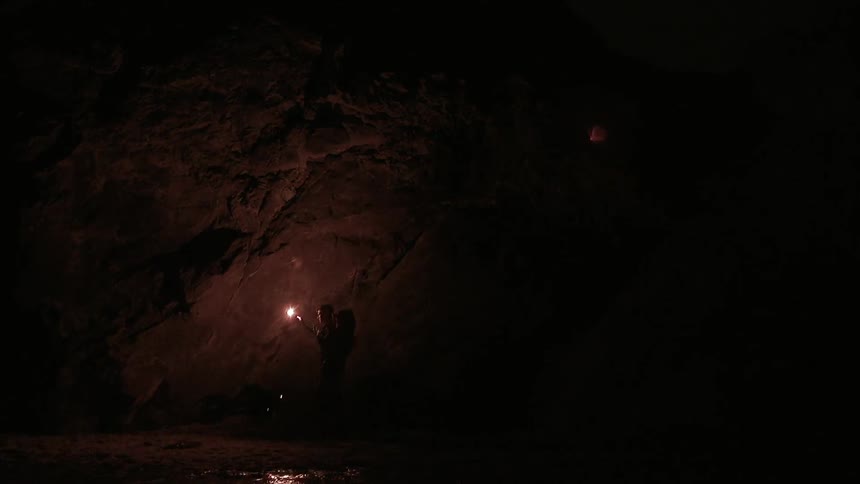 A person walking holding a torch