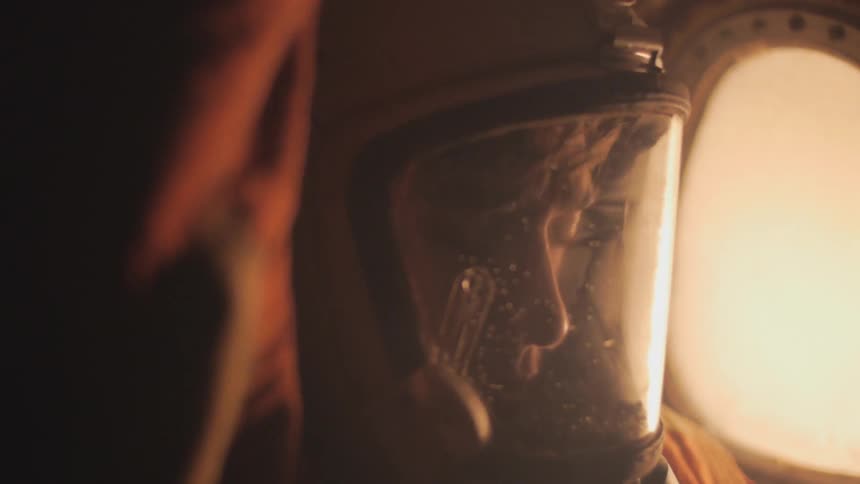 A man sits in a space suit