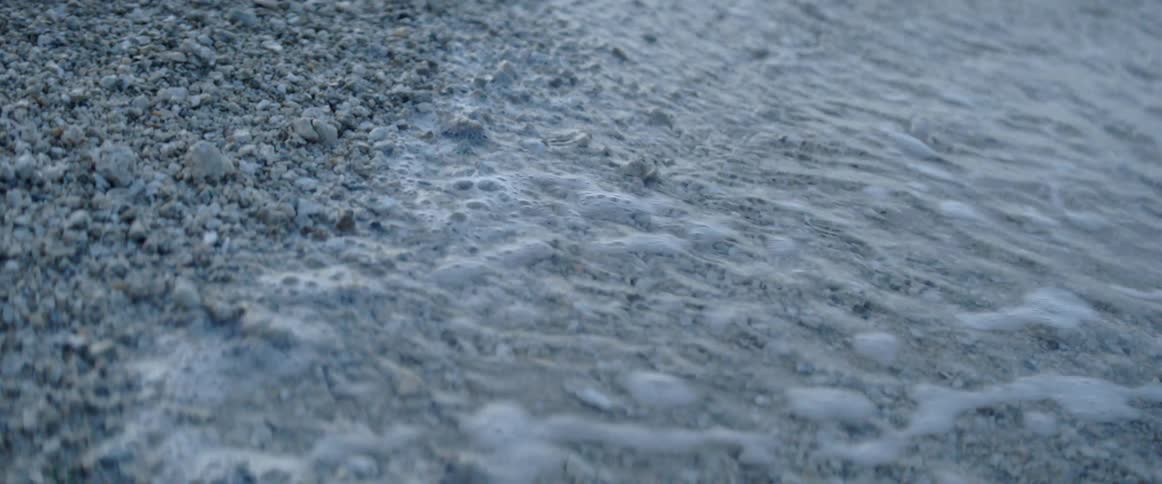 A wave is lapping the beach and then retreating