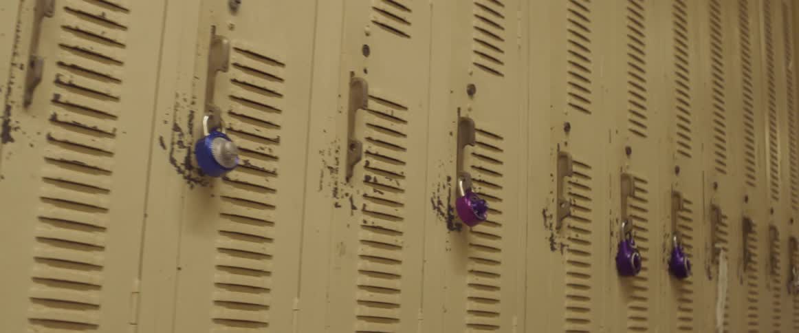 Padlocks hang on locker doors