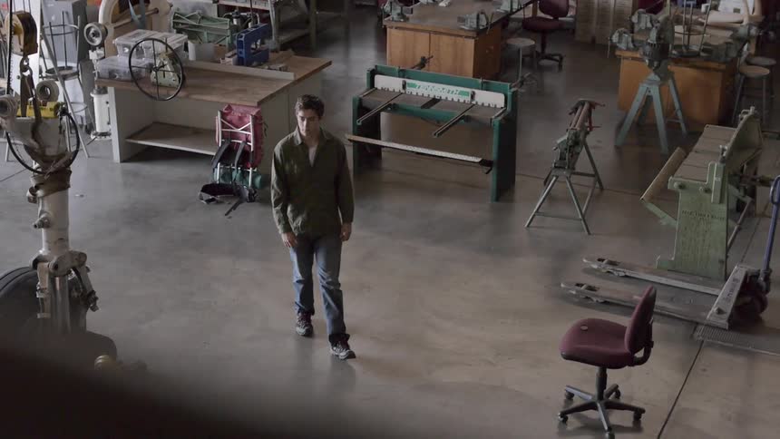 A man stands in the middle of a workshop