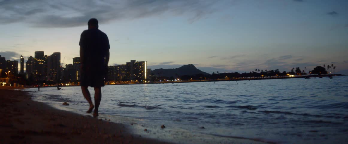 A man walks on the beach shore