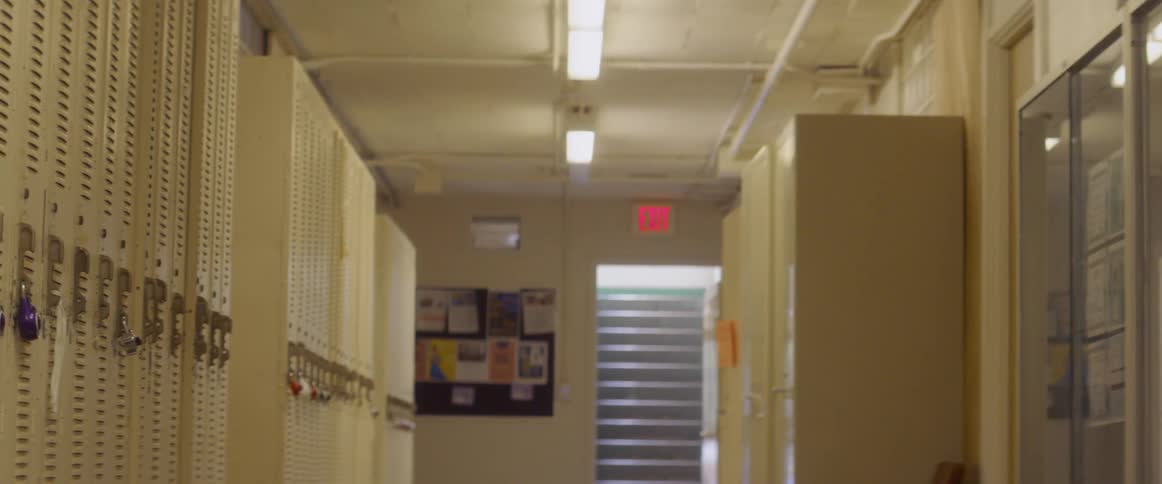 The exit sign above the door in the locker room flickers