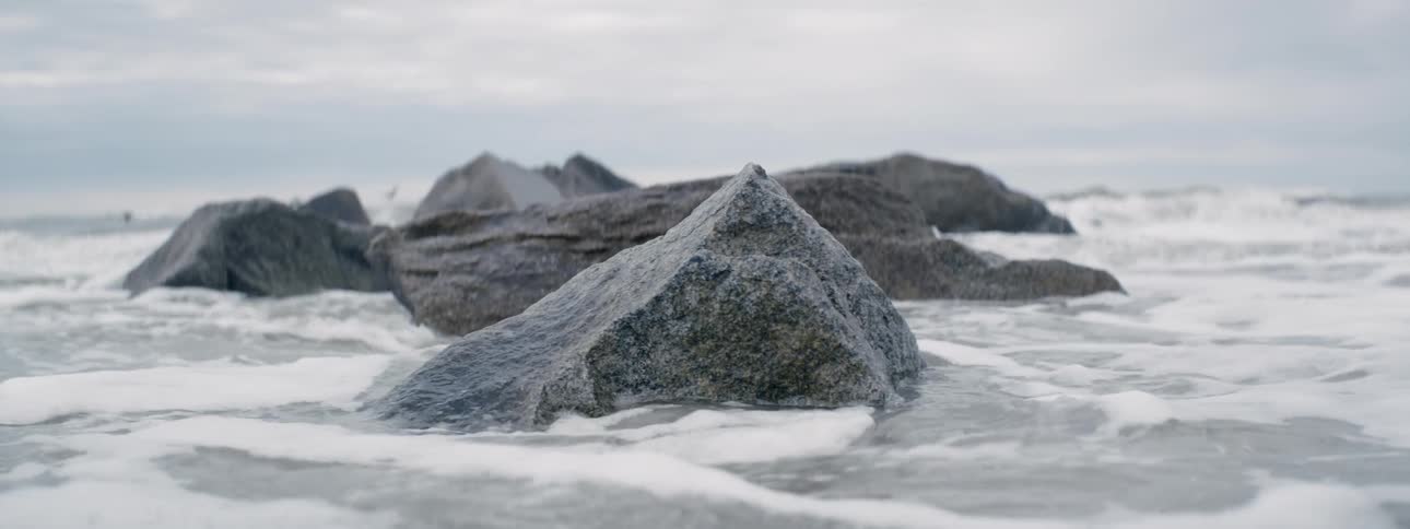 Waves crash into rocks near the shore