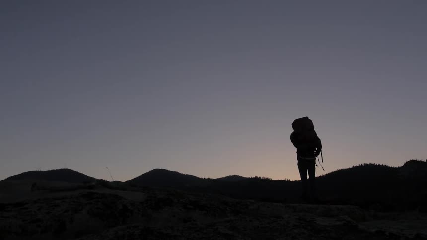 A person standing on a hill