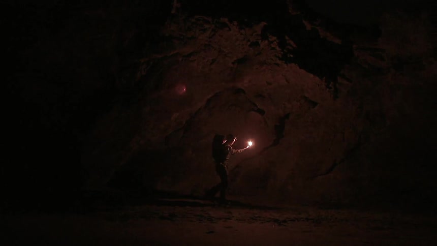 A person is standing in the darkness