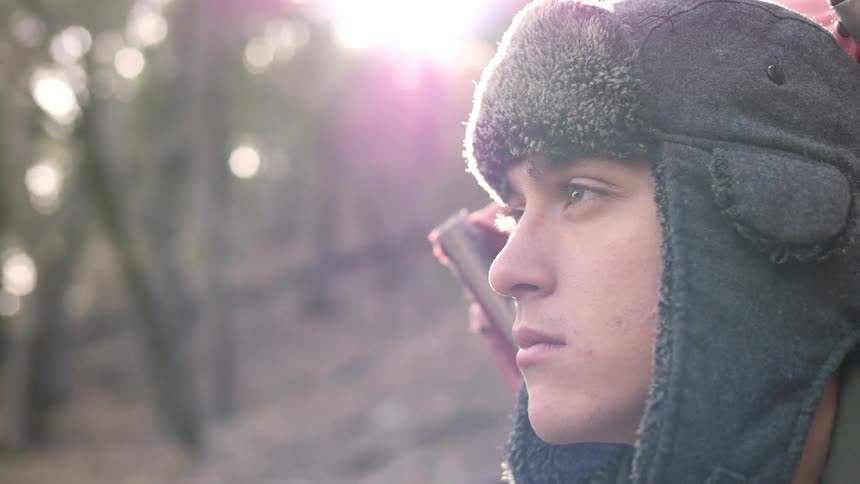 Man standing in a forest on a sunny day