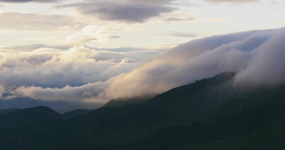Time lapse of clouds moving over a mountain top