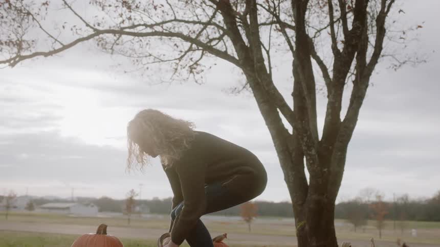 Man and woman lifting pumpkins