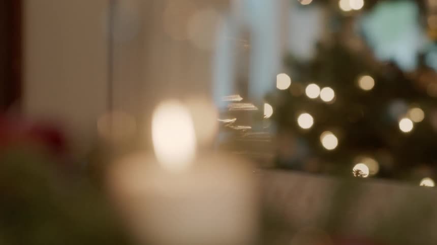Christmas decorations include garland and a white flickering candle