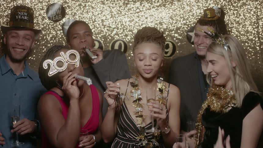 Friends posing and laughing at a new years party