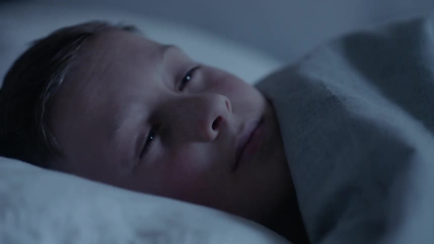 A boy wakes up and smiles