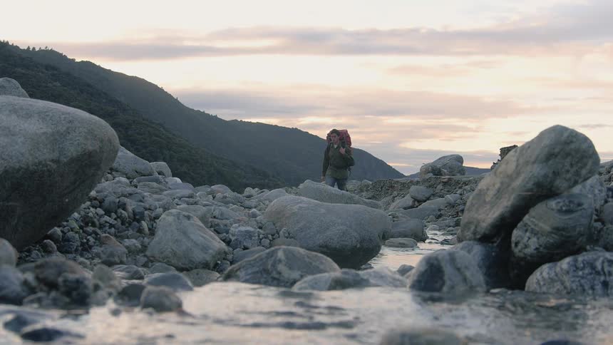 A person hiking on rocks