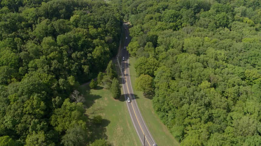 Vehicles commute on a two lane rural road