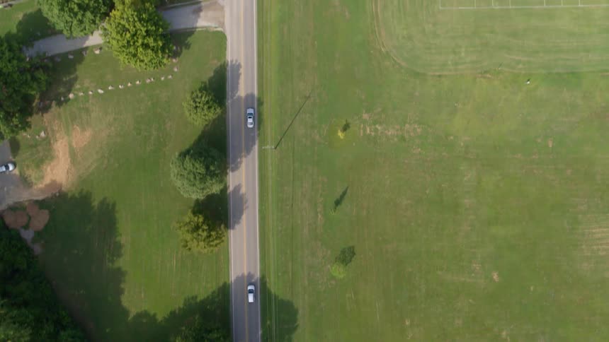 Vehicles commute on a two lane rural road