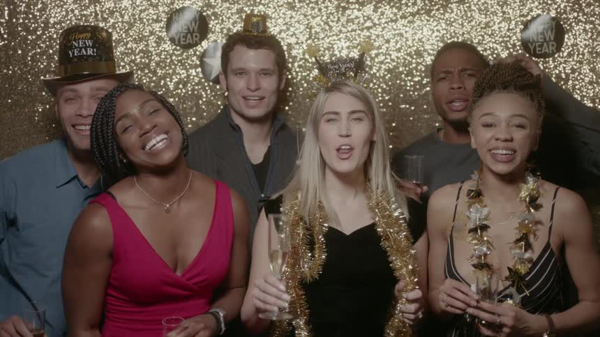A group of friends sing at a new year party