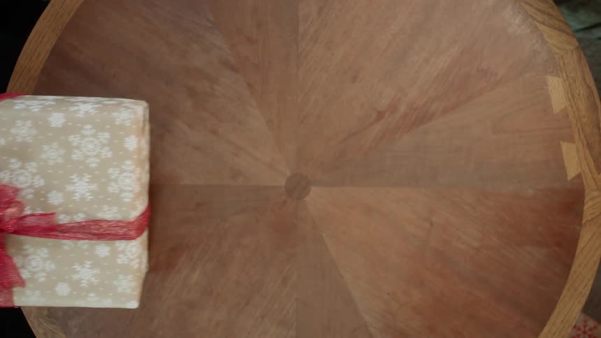 A christmas gift is exchanged over a table