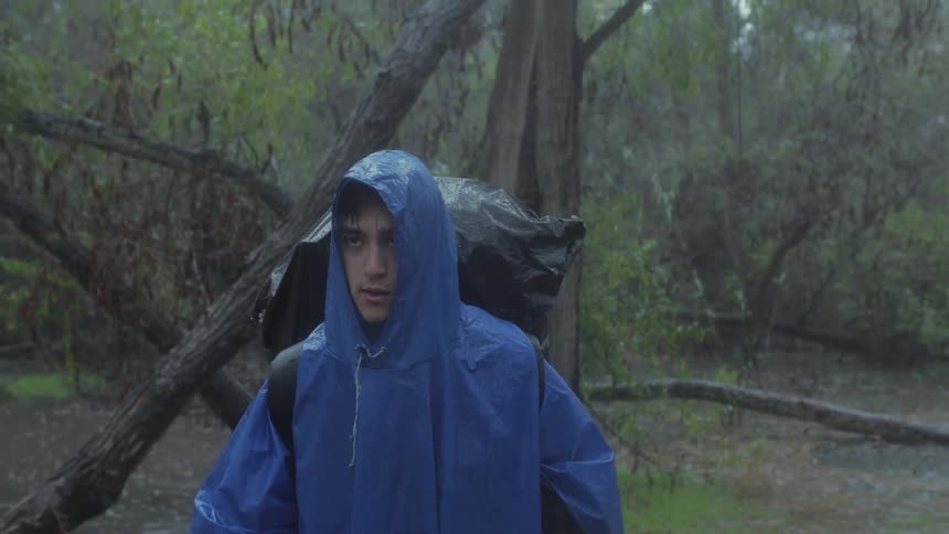Man hiking in the rain in a forest