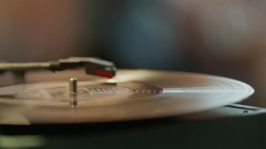 A record player plays an album