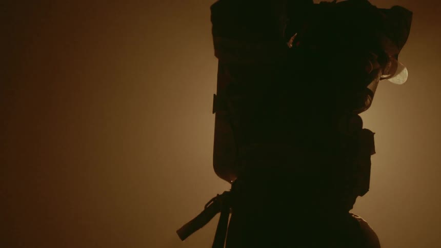 Firefighter straps on an oxygen tank