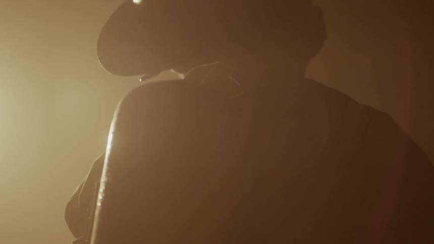 Someone is wearing a firefighter's uniform and standing in front of fire