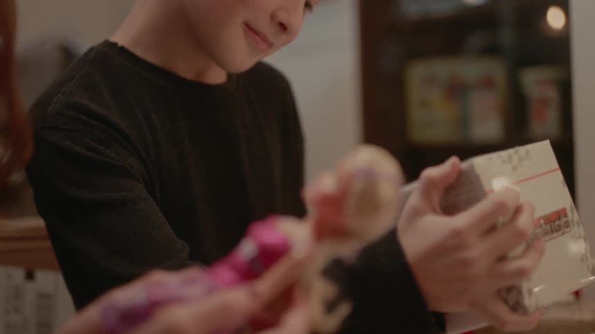 A boy and girl open christmas presents