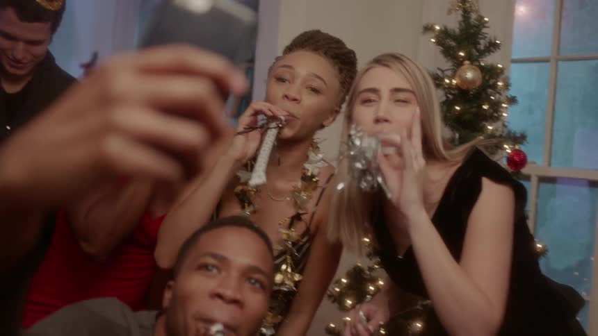 A group of friends are taking a picture as they celebrate new year's