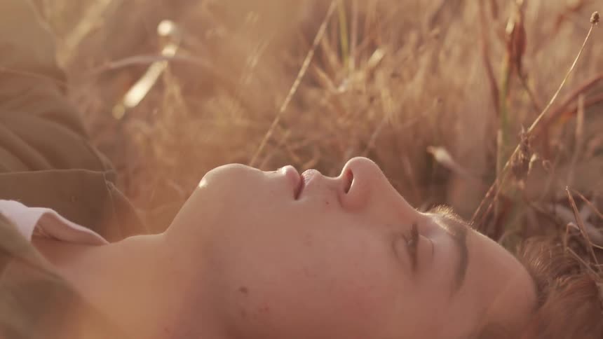 Man lying in the grass looks up on a sunny day