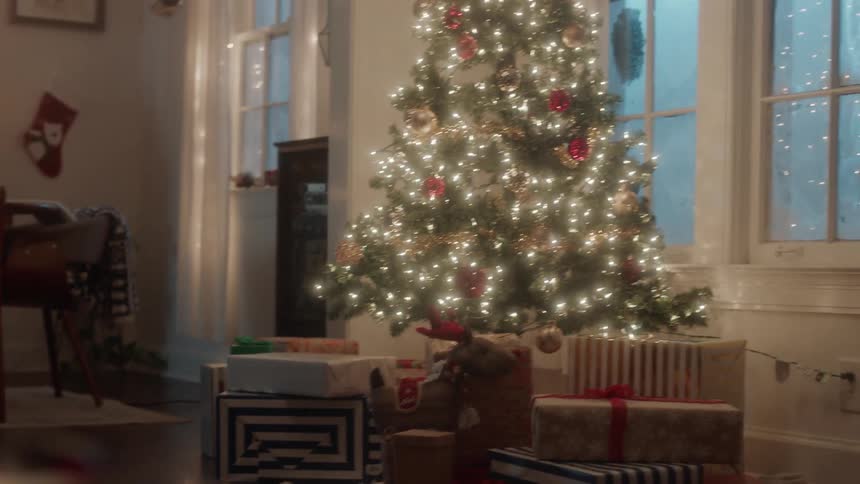Vinyl record plays on turntable near christmas tree