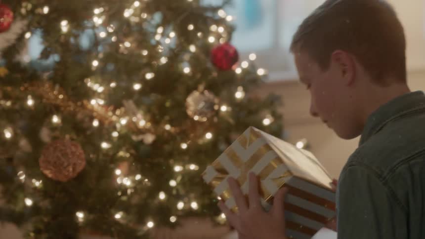 Brother and sister pick up presents and shake them