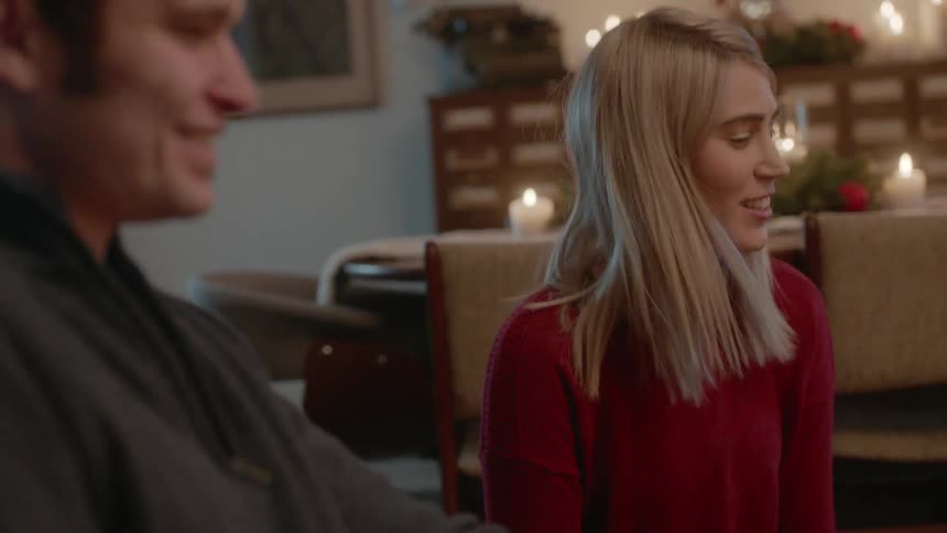 A man and woman smile at each other on christmas