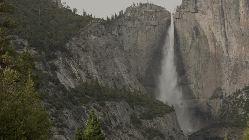 A waterfall falls over a mountain
