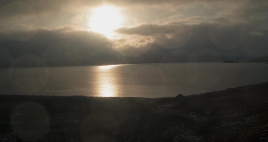 The sun is shining down upon the cabin and ocean vista