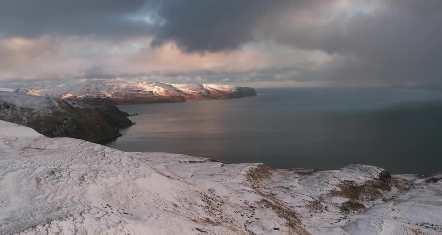 Storm clouds are hanging over a remote coast in winter