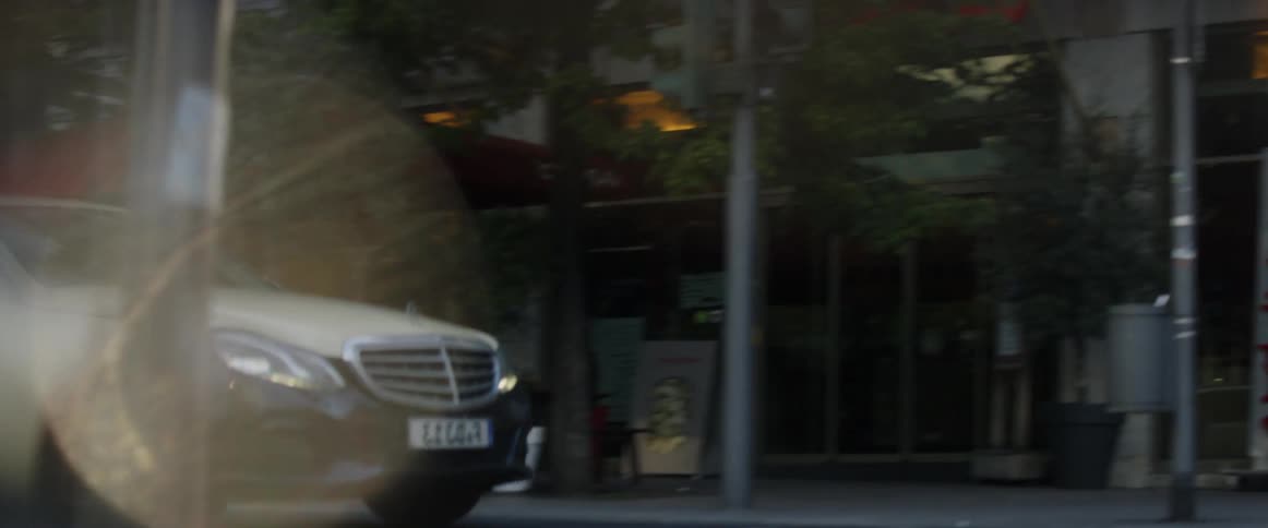 Cars drive on a city street
