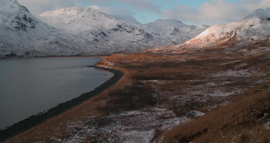 Snowy mountains surround a lake