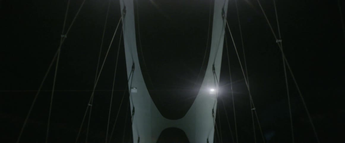 A large bridge at night with lights on